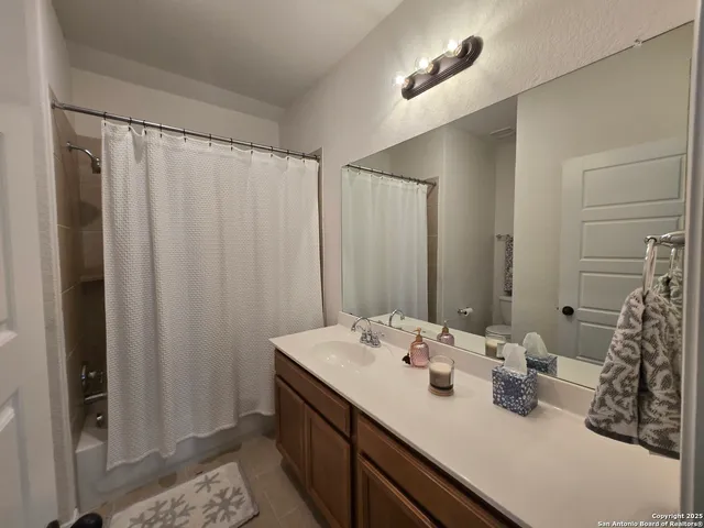 a bathroom with a double vanity sink and a mirror