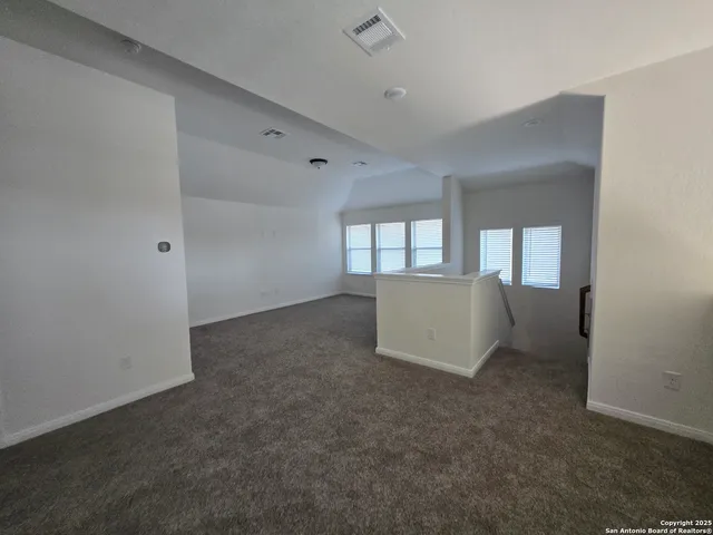 an empty room with a empty space and windows