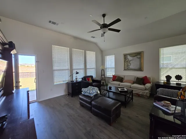 a living room with furniture and wooden floor