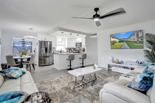 a living room with furniture and kitchen view