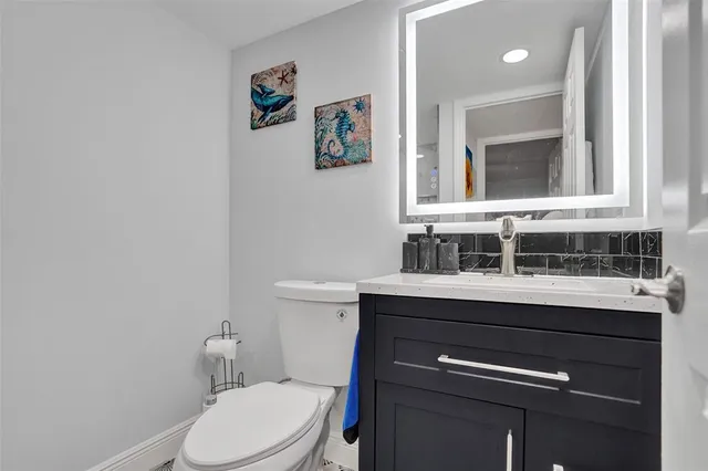 a bathroom with a sink a toilet and mirror