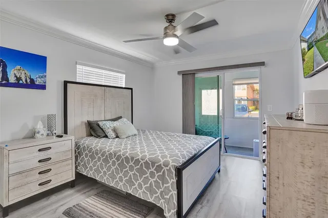 a bedroom with a large bed and a chandelier