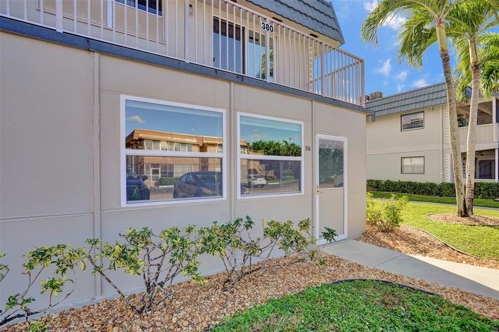 356 Brittany Avenue, Unit 356 Delray Beach, FL 33446 - Photo 28 of 31 a front view of a house with garden