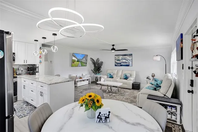 a living room with fireplace furniture and a chandelier