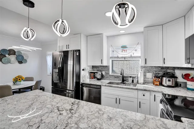 a kitchen with cabinets and window