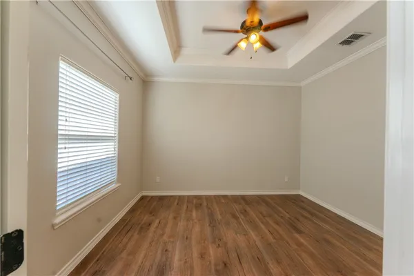 a view of room with window and wooden floor