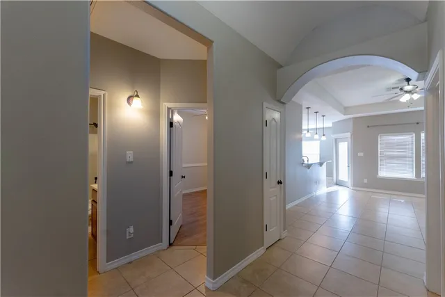 a view of a hallway with wooden shelves