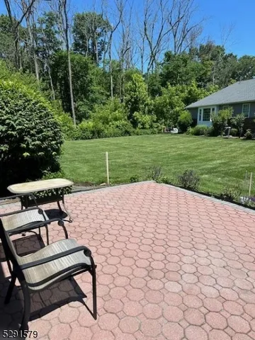 a view of a backyard with sitting area