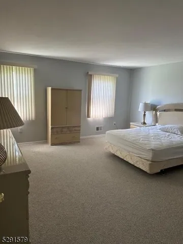 a bedroom with a bed and a cabinets