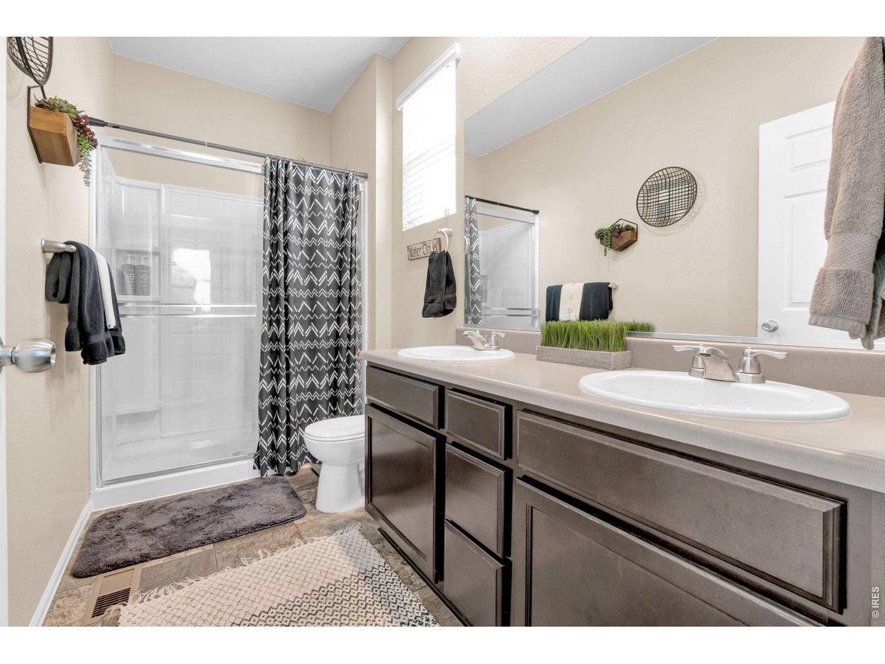 512 Buckrake Street Severance, CO 80550 - Photo 16 of 41 a bathroom with a sink and a mirror