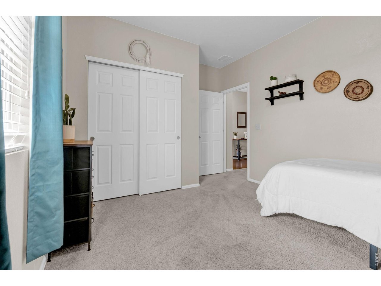 512 Buckrake Street Severance, CO 80550 - Photo 18 of 41 a bedroom with a bed and a book shelf