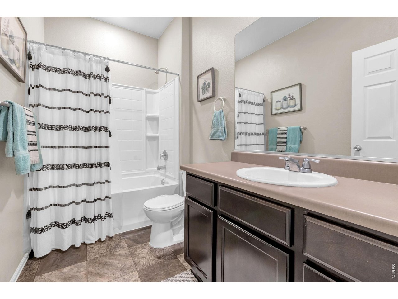512 Buckrake Street Severance, CO 80550 - Photo 19 of 41 a bathroom with a sink toilet a shower and a mirror