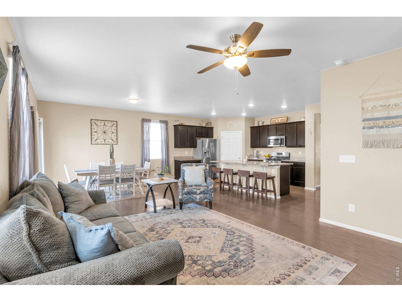 512 Buckrake Street Severance, CO 80550 - Photo 4 of 41 a living room with furniture kitchen view and a chandelier