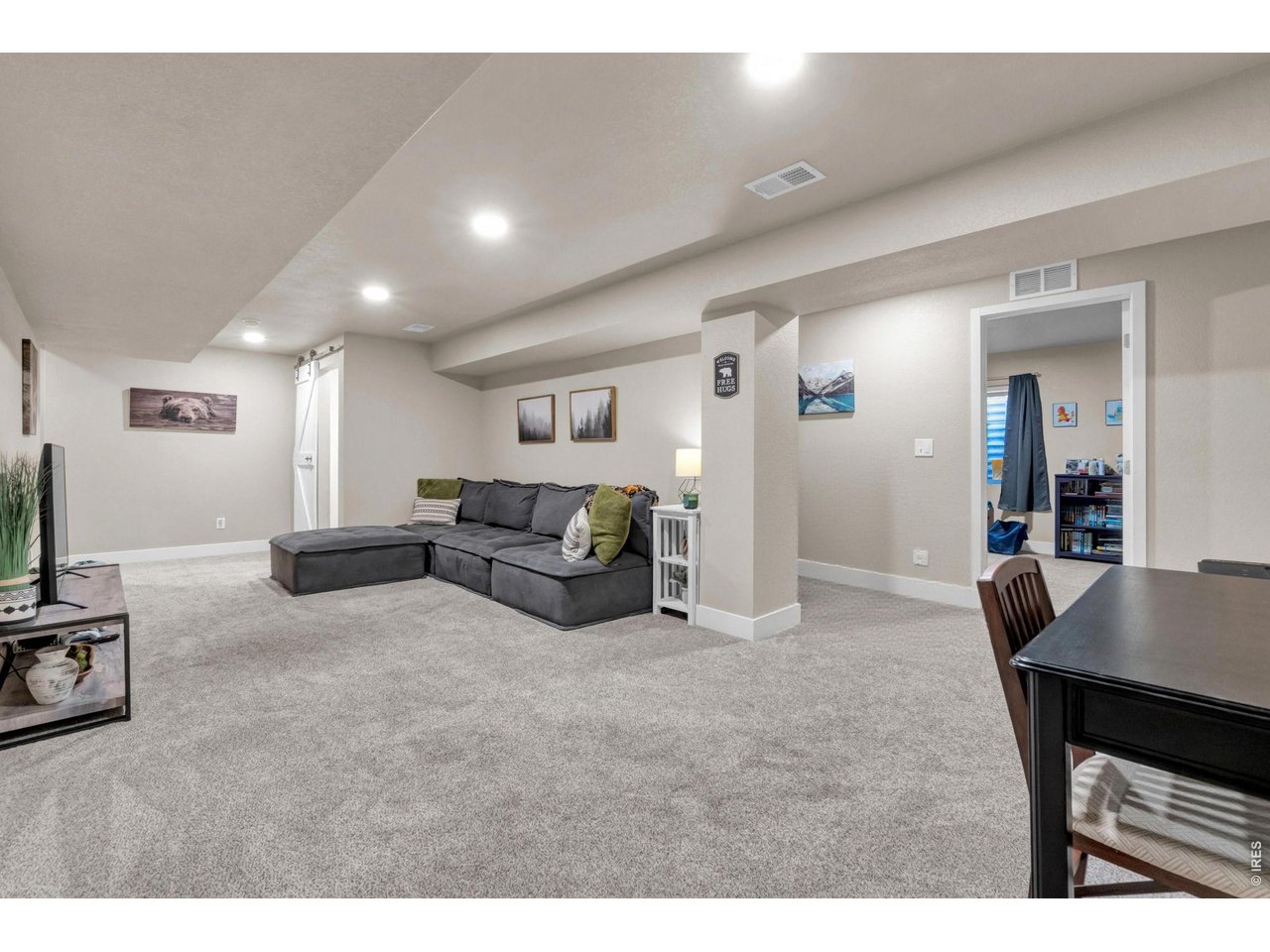 512 Buckrake Street Severance, CO 80550 - Photo 6 of 41 a living room with furniture a table and a flat screen tv
