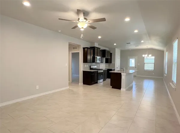 a kitchen with stainless steel appliances a refrigerator and a microwave