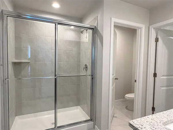 a bathroom with a glass shower door