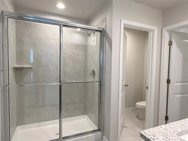a bathroom with a glass shower door