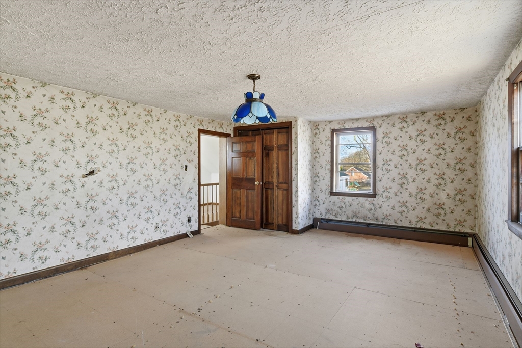 1601 Westover Road Chicopee, MA 01020 - Photo 28 of 32 wooden floor in an empty room with a window