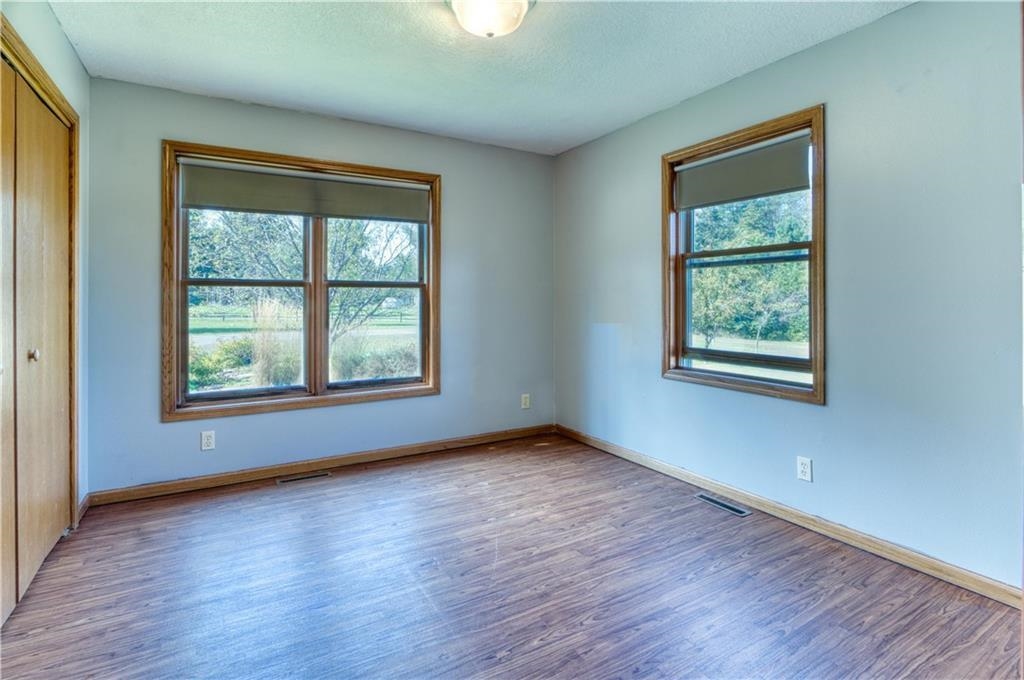9018 North Anderson Road Hayward, WI 54843 - Photo 21 of 42 Unfurnished bedroom with a closet, wood finished floors, and a textured ceiling