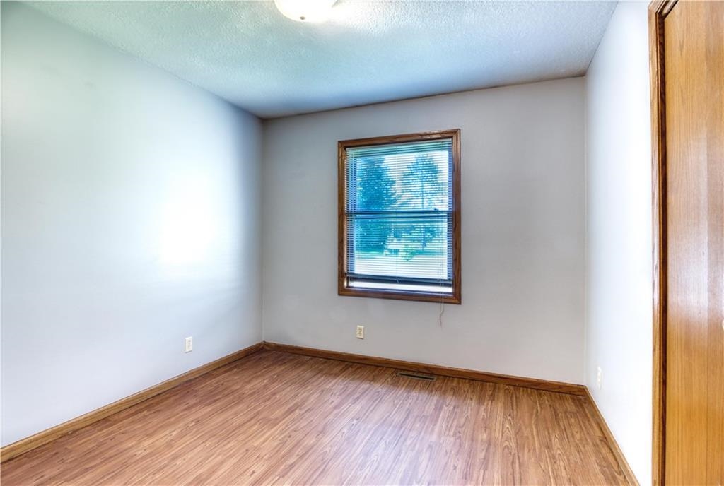 9018 North Anderson Road Hayward, WI 54843 - Photo 22 of 42 Unfurnished room featuring wood finished floors and a textured ceiling
