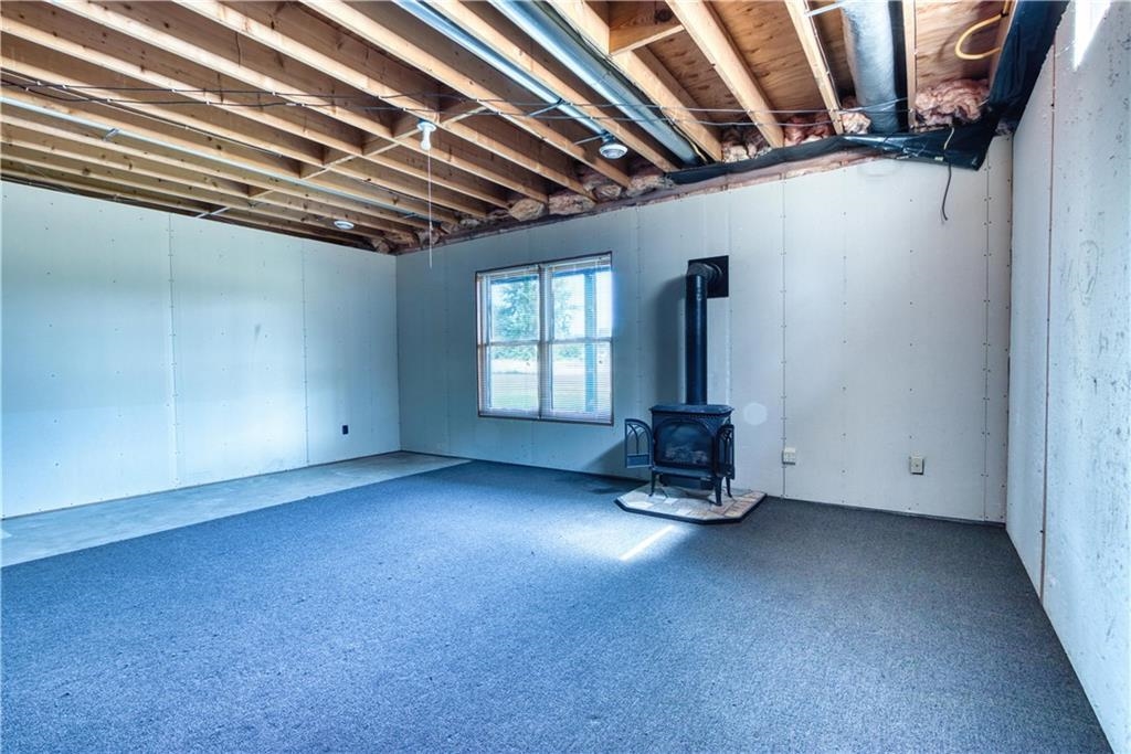 9018 North Anderson Road Hayward, WI 54843 - Photo 24 of 42 Basement featuring a wood stove