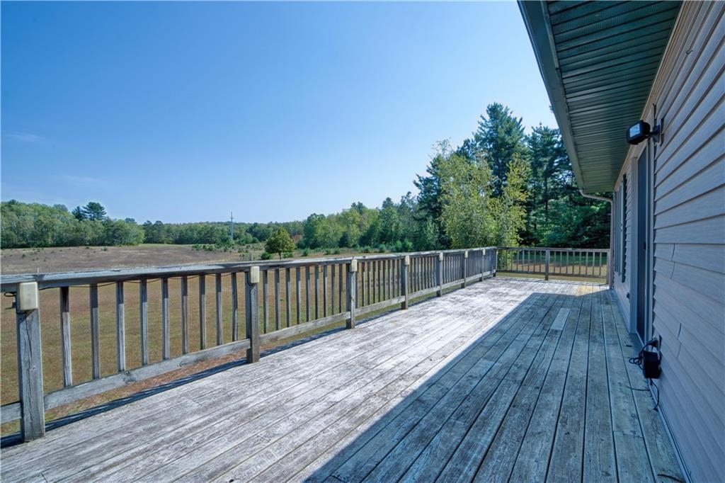 9018 North Anderson Road Hayward, WI 54843 - Photo 25 of 42 Wooden deck with view of wooded area