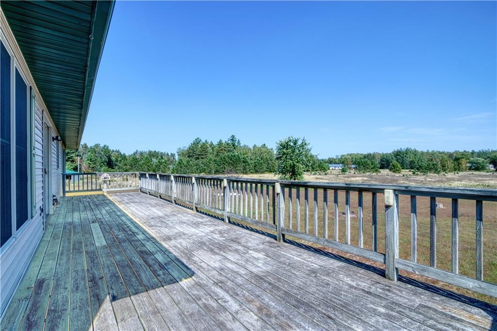 9018 North Anderson Road Hayward, WI 54843 - Photo 26 of 42 Wooden terrace featuring view of wooded area