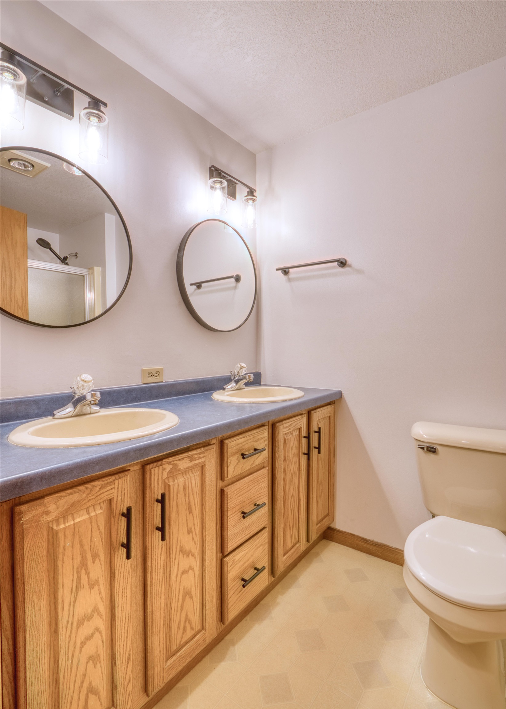 9018 North Anderson Road Hayward, WI 54843 - Photo 41 of 42 Full bath with double vanity, a textured ceiling, and light floors