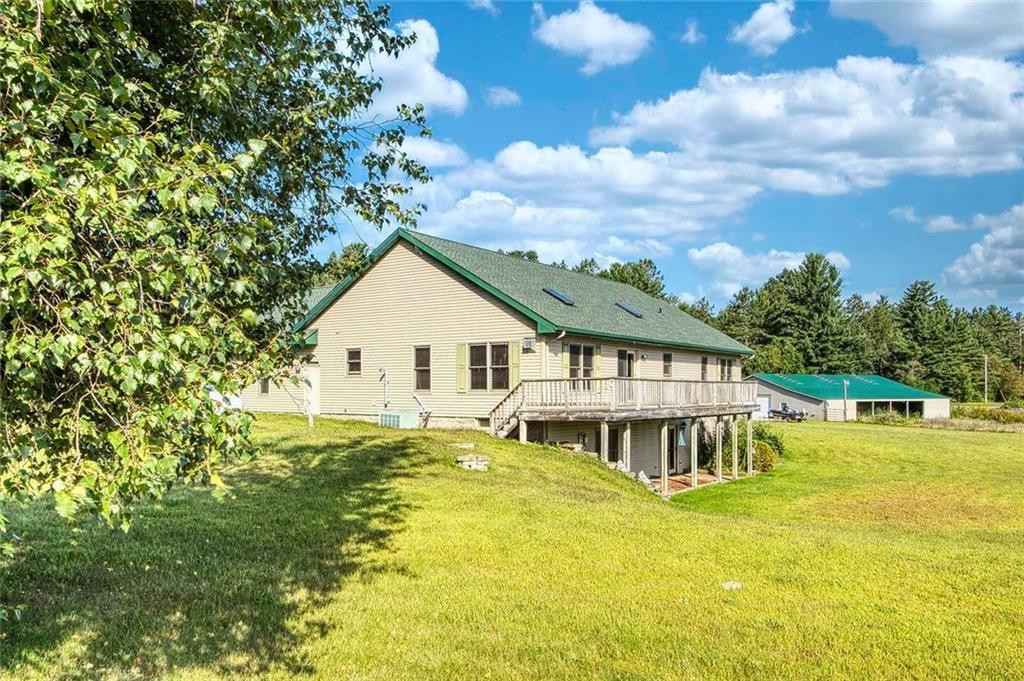 9018 North Anderson Road Hayward, WI 54843 - Photo 6 of 42 Back of house with a wooden deck and a yard