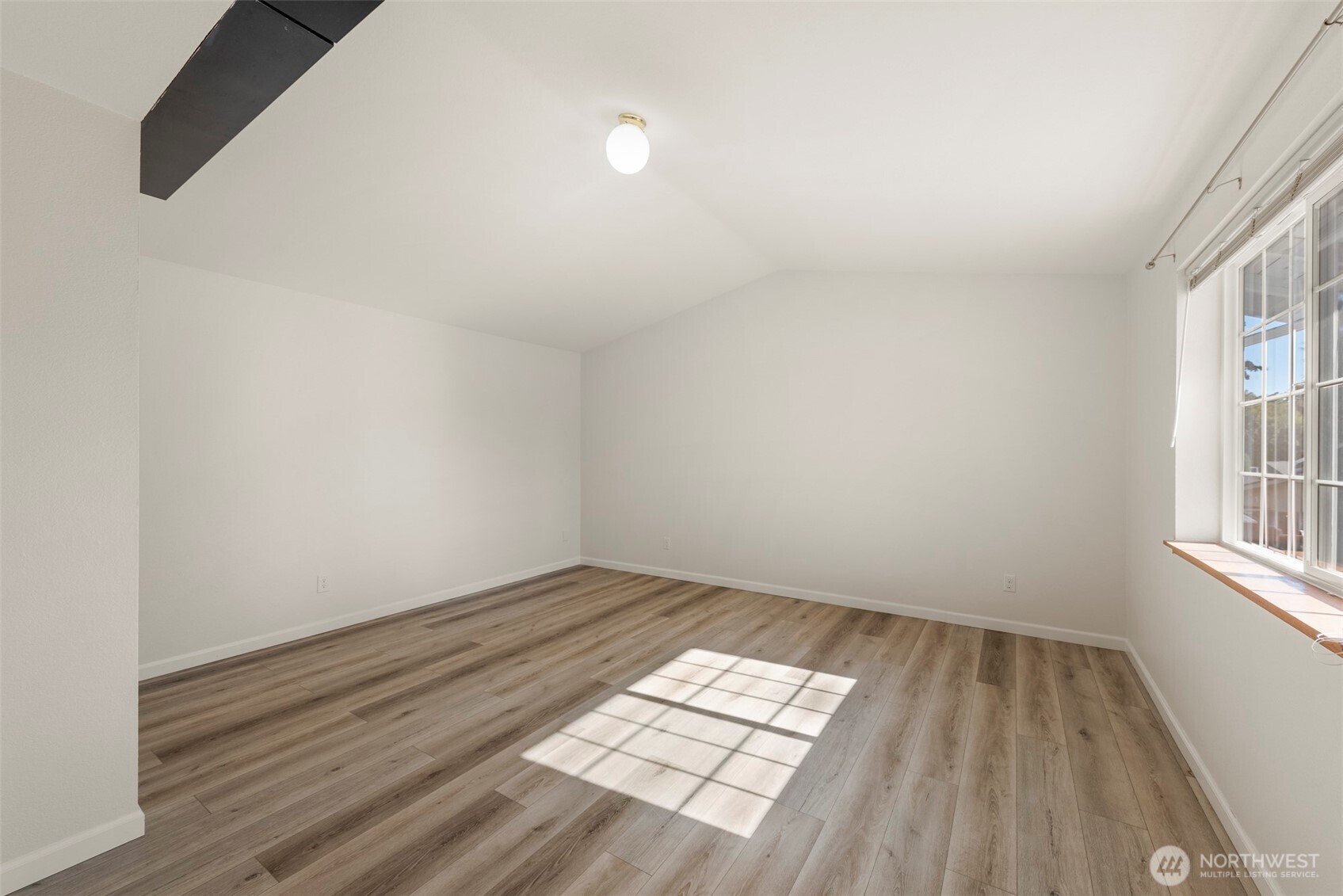 5703 134th Place Southeast, Unit A Snohomish, WA 98296 - Photo 16 of 20 an empty room with wooden floor and windows