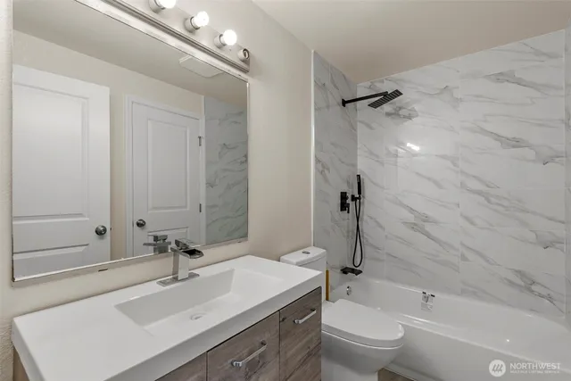 a bathroom with a sink toilet tub and shower