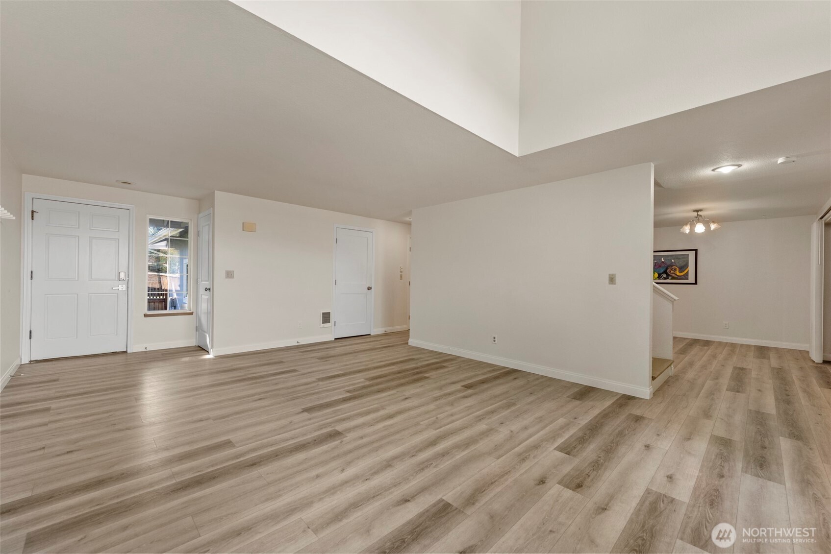 5703 134th Place Southeast, Unit A Snohomish, WA 98296 - Photo 4 of 20 a view of an empty room with wooden floor and a window