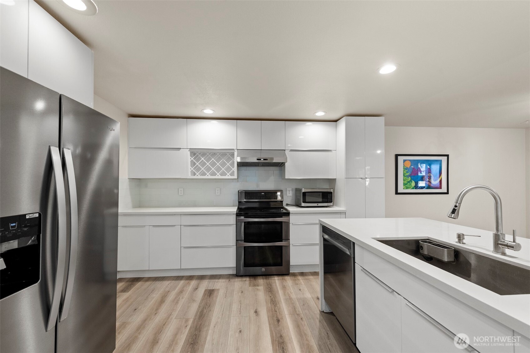 5703 134th Place Southeast, Unit A Snohomish, WA 98296 - Photo 7 of 20 a kitchen with a sink stainless steel appliances and cabinets