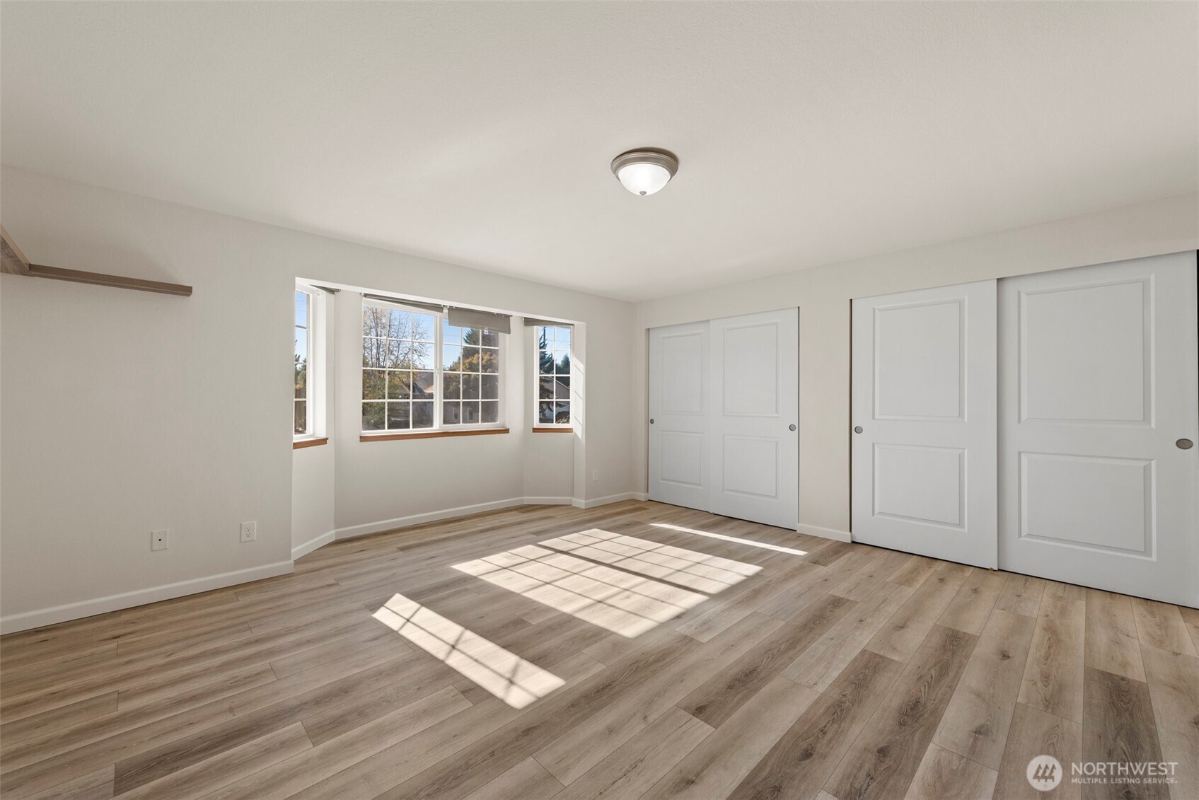 5703 134th Place Southeast, Unit A Snohomish, WA 98296 - Photo 9 of 20 a view of an empty room with wooden floor and a window