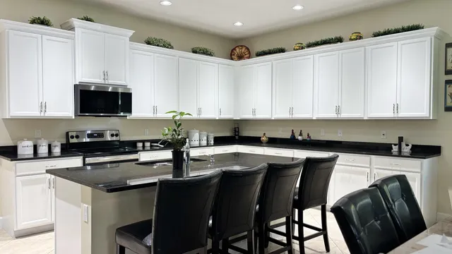a living room with furniture a window and a flat screen tv