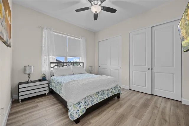 a view of a house with a yard and potted plants