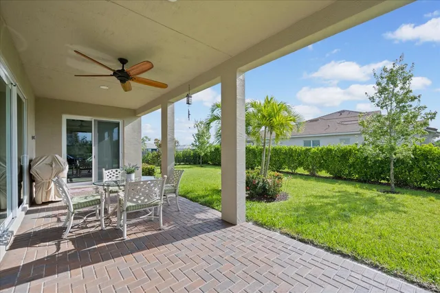 a view of a house with backyard and sitting area