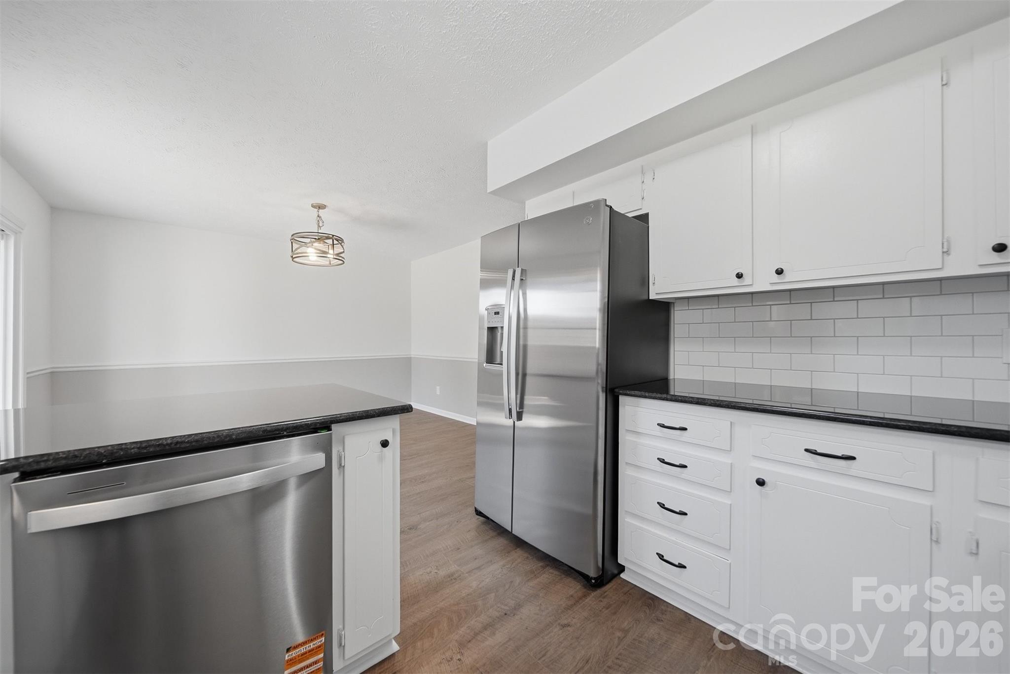 414 7th Street Northeast, Unit 2 Hickory, NC 28601 - Photo 11 of 36 a kitchen with cabinets and stainless steel appliances