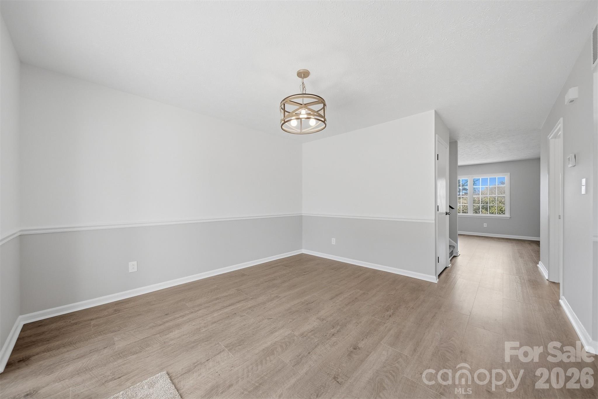 414 7th Street Northeast, Unit 2 Hickory, NC 28601 - Photo 13 of 36 an empty room with wooden floor and windows