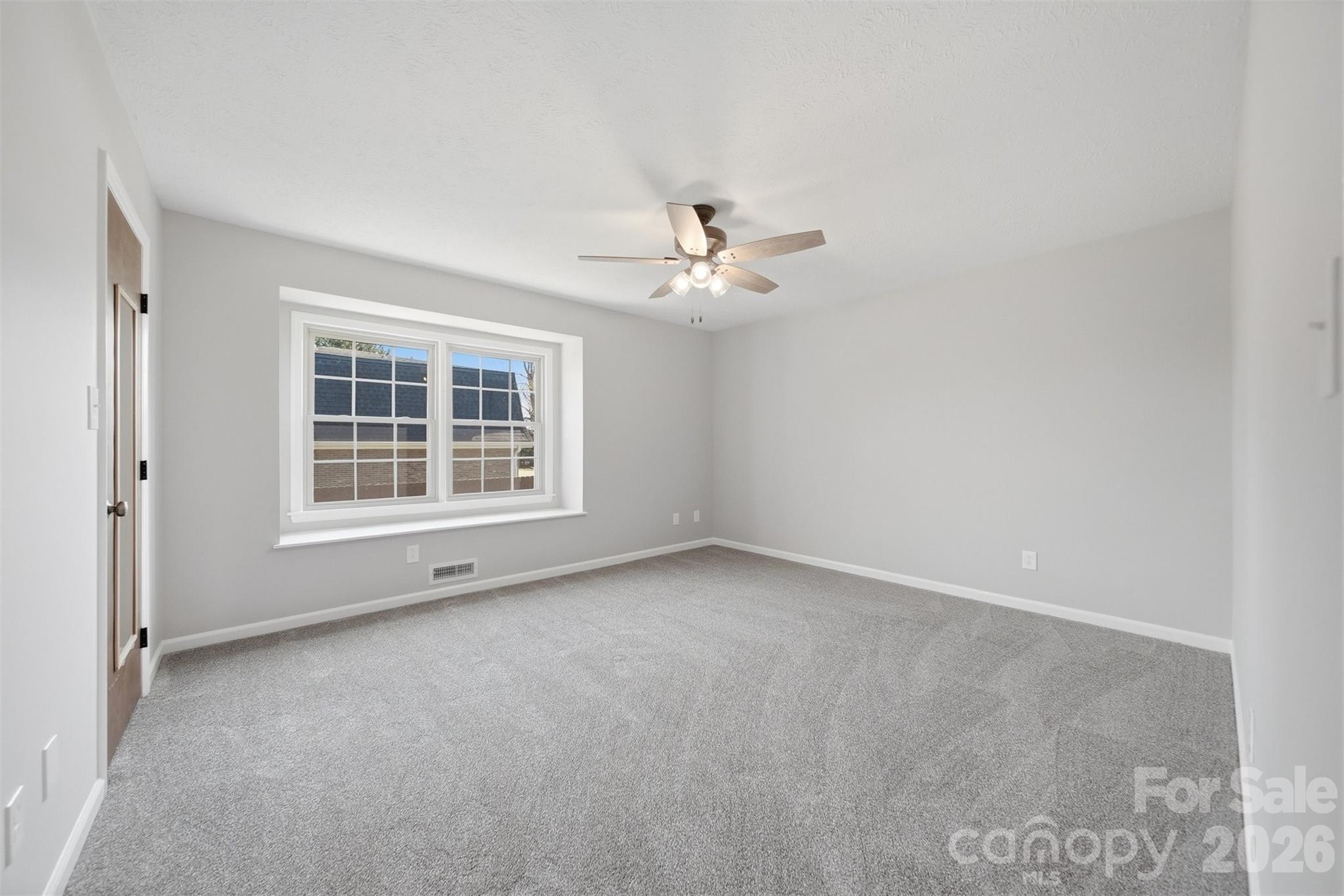414 7th Street Northeast, Unit 2 Hickory, NC 28601 - Photo 17 of 36 an empty room with windows and fan