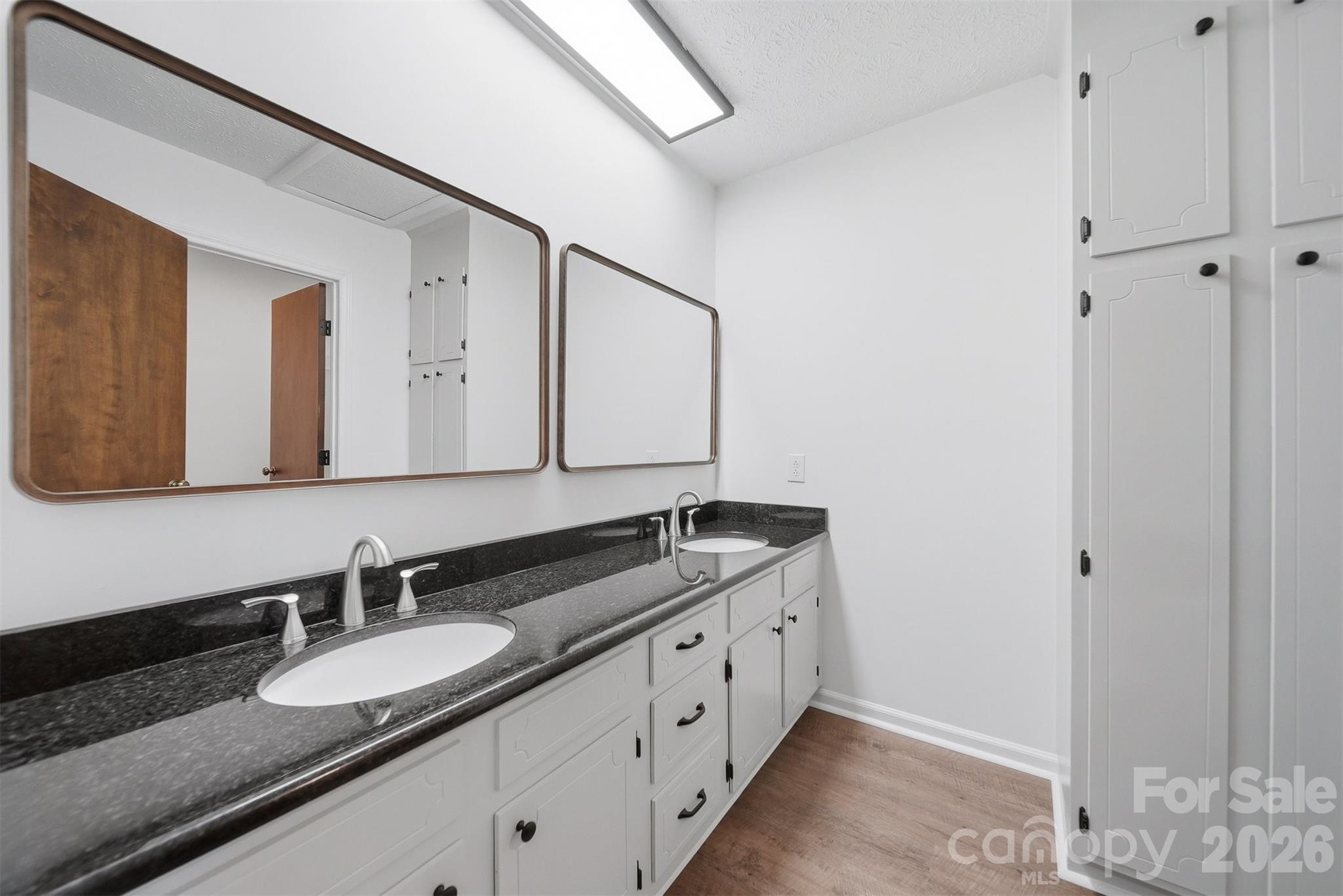 414 7th Street Northeast, Unit 2 Hickory, NC 28601 - Photo 20 of 36 a bathroom with a granite countertop sink and a mirror