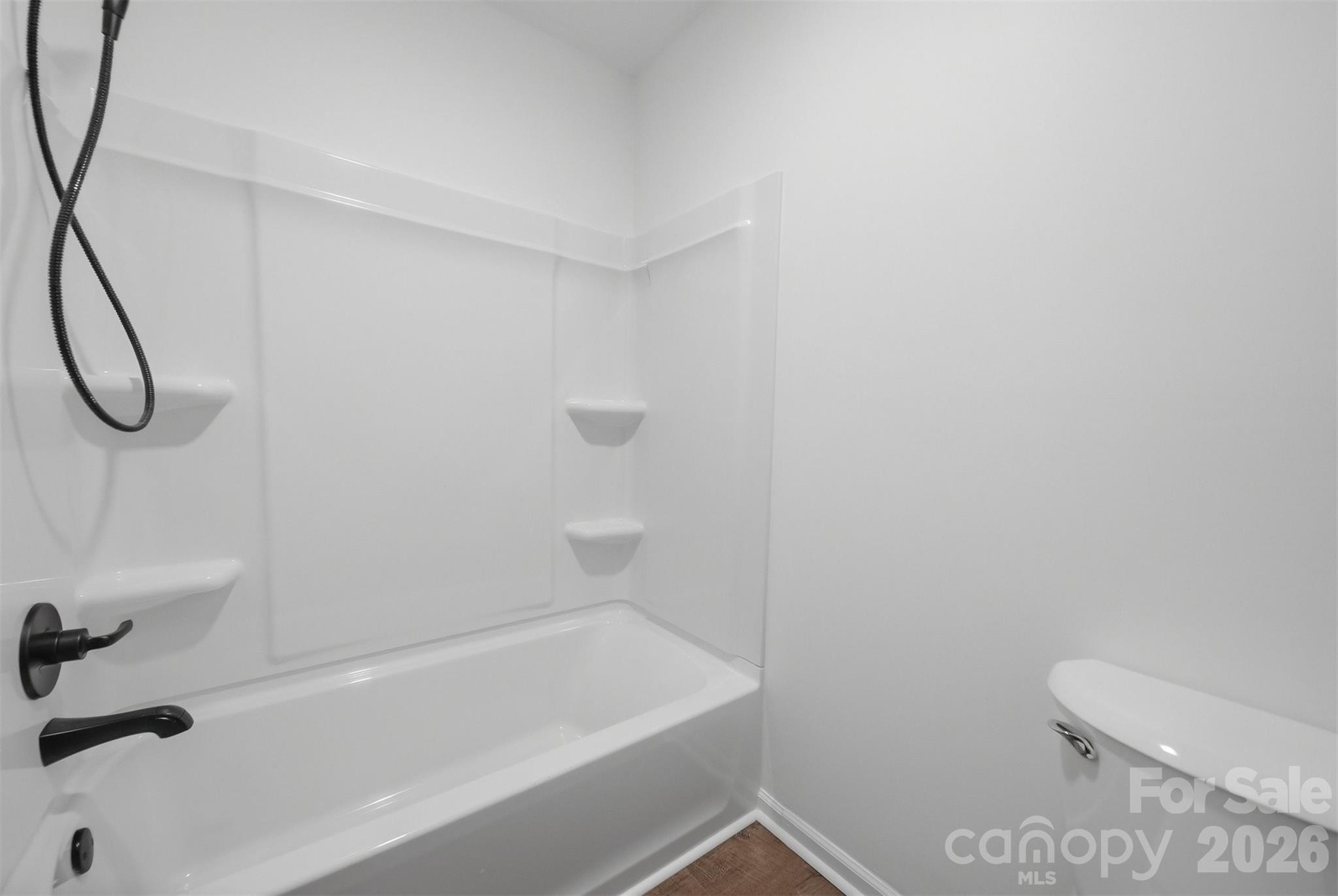 414 7th Street Northeast, Unit 2 Hickory, NC 28601 - Photo 22 of 36 a bathroom with a bathtub and a toilet