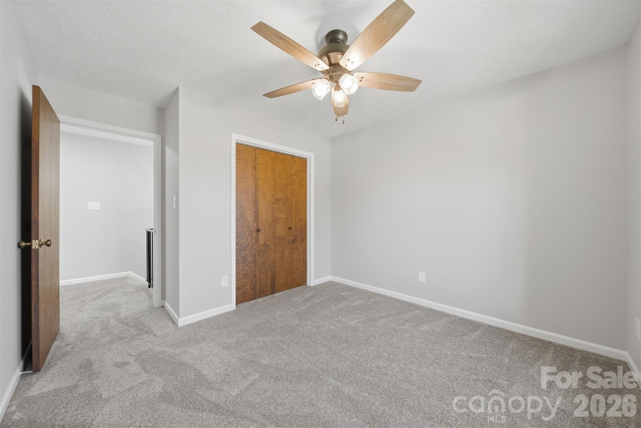 414 7th Street Northeast, Unit 2 Hickory, NC 28601 - Photo 23 of 36 an empty room with closet and a chandelier fan