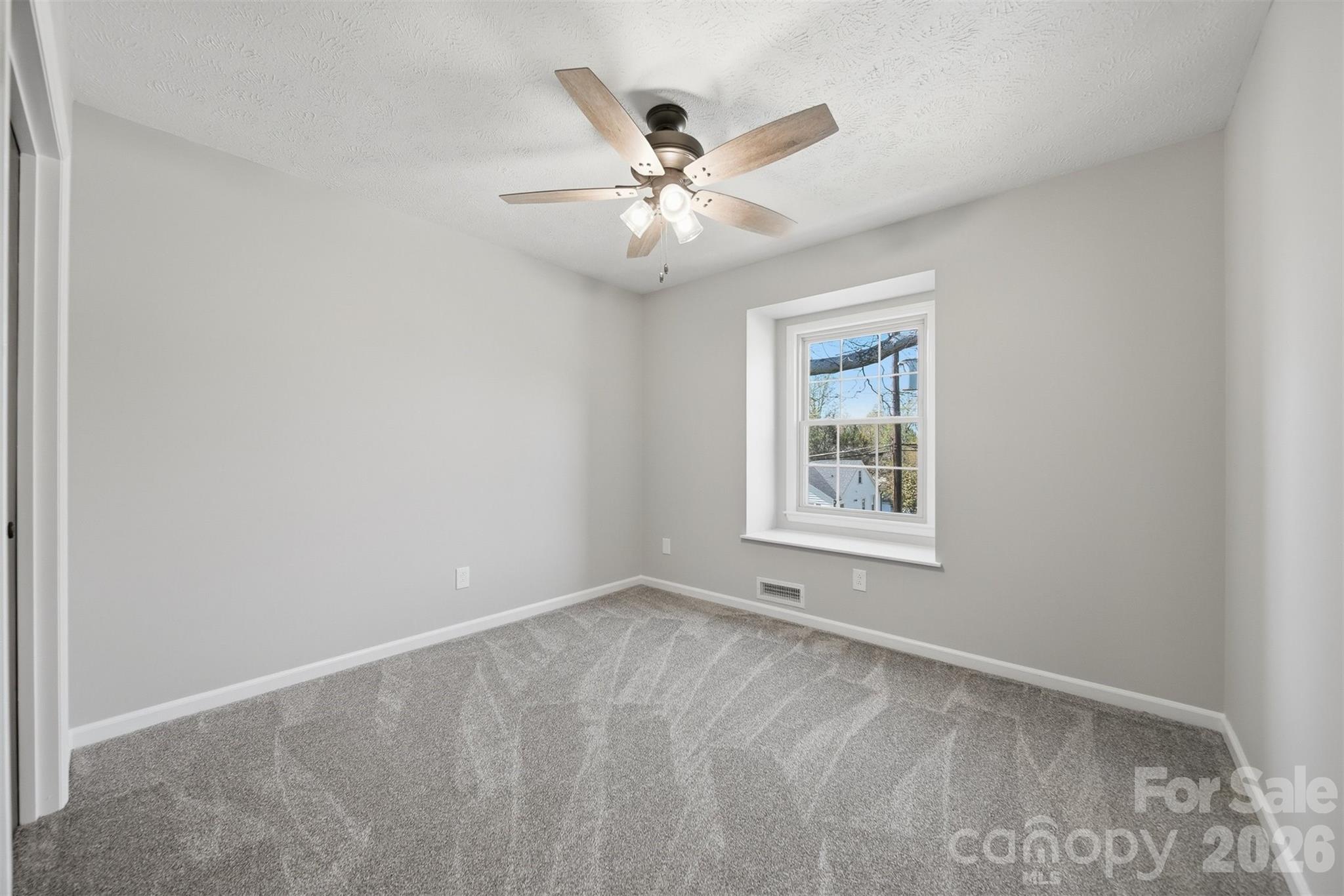 414 7th Street Northeast, Unit 2 Hickory, NC 28601 - Photo 24 of 36 an empty room with window and ceiling fan