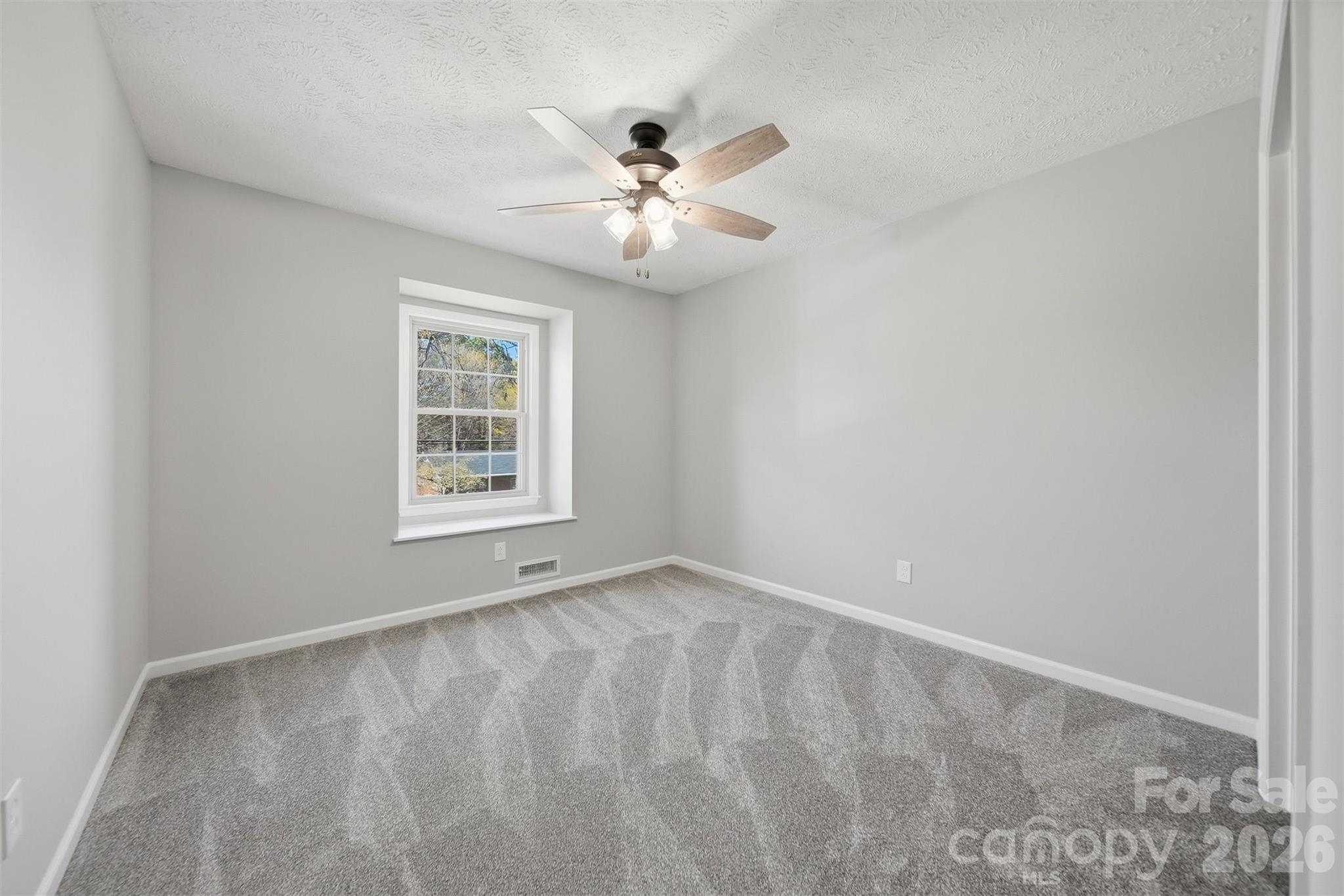 414 7th Street Northeast, Unit 2 Hickory, NC 28601 - Photo 27 of 36 an empty room with windows and fan