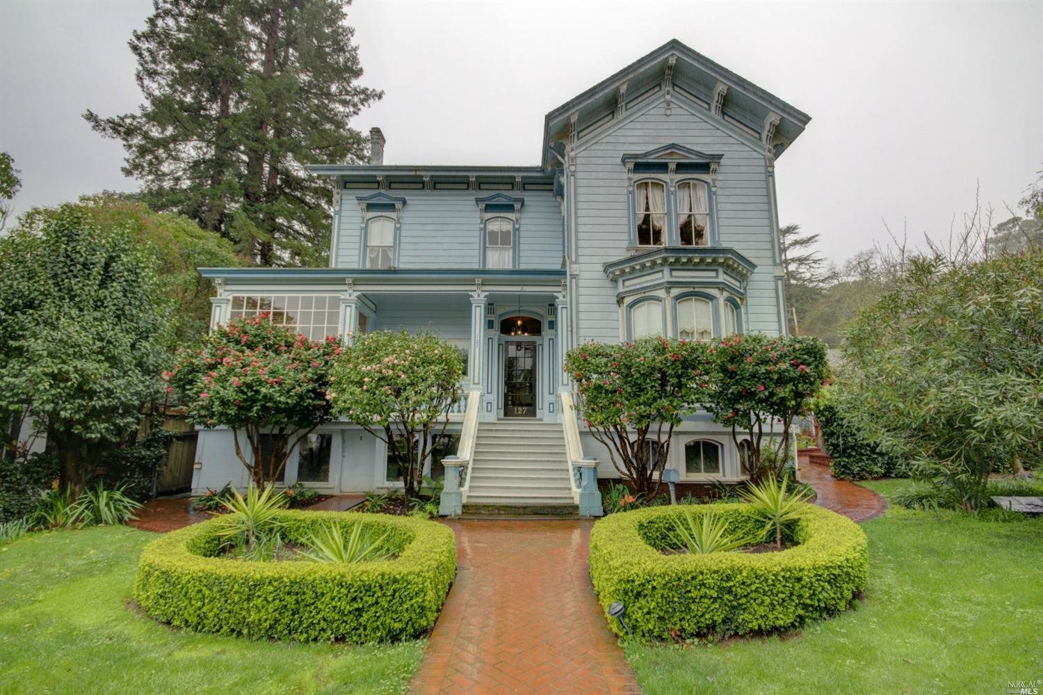 a front view of a house with garden