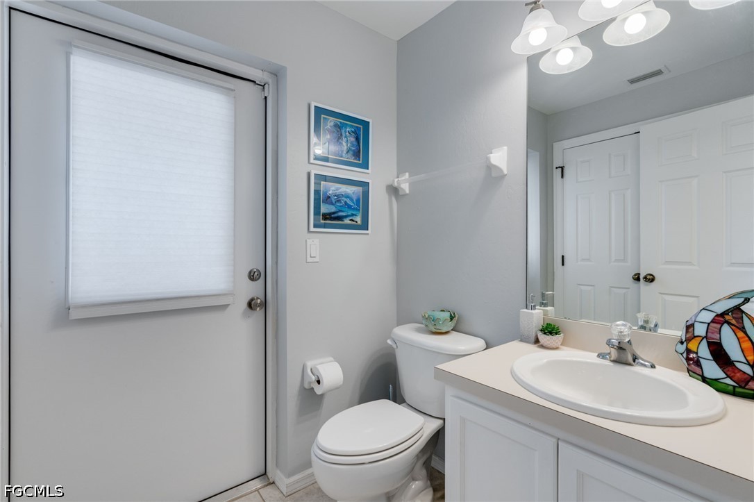 3801 28th Street Southwest Lehigh Acres, FL 33976 - Photo 21 of 37 a bathroom with a sink toilet and a mirror