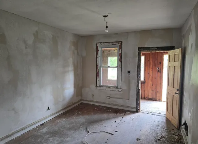 a room with a wooden floor and a sink