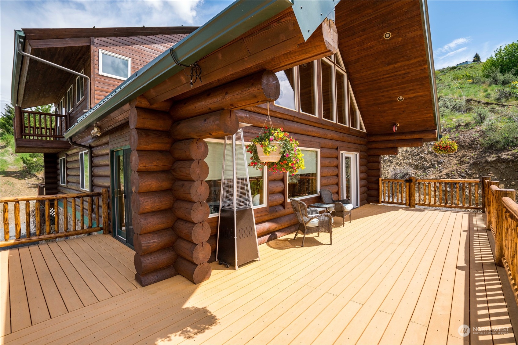 a view of a brick house with large windows and wooden floor