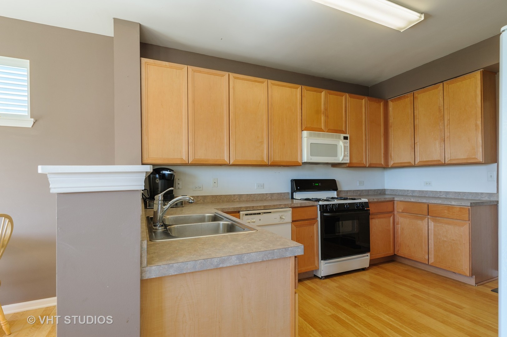 1858 South Fallbrook Drive Round Lake, IL 60073 - Photo 4 of 10 a kitchen with a sink stove and cabinets